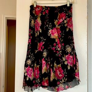 Rose printed knee long silk skirt with diagonal flounce in the front. Size M